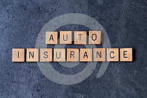 `Auto Insurance` spelled out in wooden letter tiles