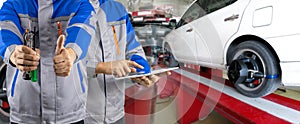 Auto mechanic analyzes and aligns automobile a wheels. The car checks the wheel sensors on for wheels alignment