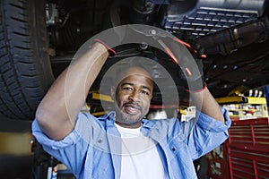 Auto Mechanic Beneath A Car photo