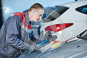 Auto mechanic buffing car autobody