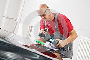 Auto mechanic buffing car autobody