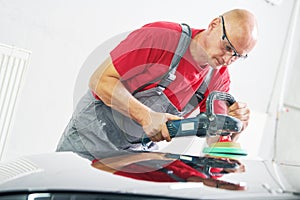 Auto mechanic buffing car autobody