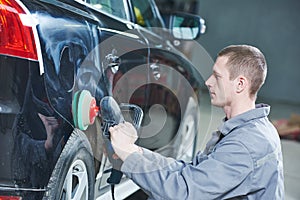 Auto mechanic buffing car autobody