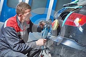 Auto mechanic buffing car autobody