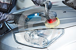 Auto mechanic buffing car autobody bonnet