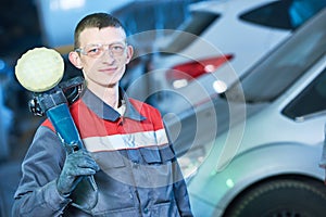 Auto mechanic with buffing machine photo