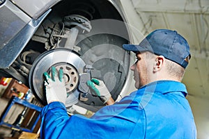 Auto mechanic at car suspension repairing