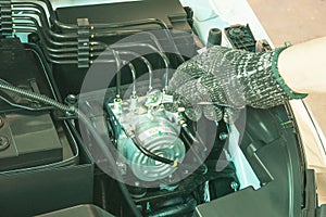 Auto mechanic Checking ABS Pump ECU module, Car maintenance service