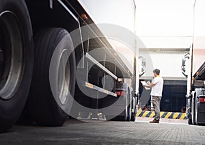 Auto Mechanic is Checking the Truck`s Safety Maintenance Checklist. Lorry Driver. Inspection Truck Safety of Semi Truck Wheels.