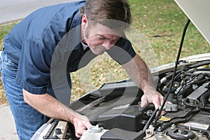 Auto Mechanic Checks Engine