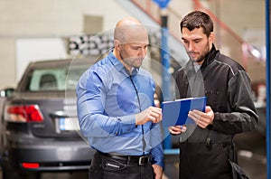 Auto mechanic and customer at car shop