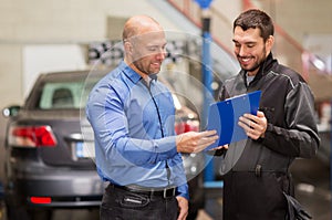 Auto mechanic and customer at car shop