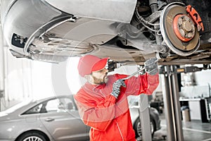 Auto mechanic diagnosing car at the car service