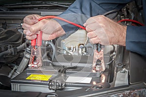 Auto mechanic engaged in the maintenance of the battery