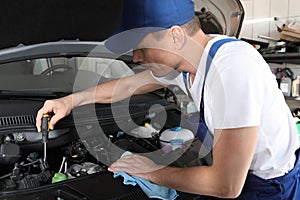 Auto mechanic fixing modern car in service center