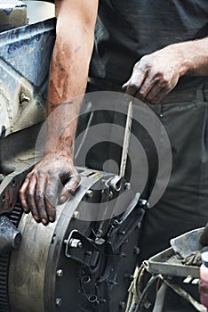 Auto mechanic hands at car repair work