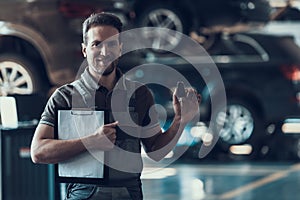 Auto Mechanic Holding Clipboard and Car Keys