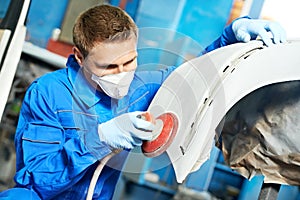 Auto mechanic polishing car photo