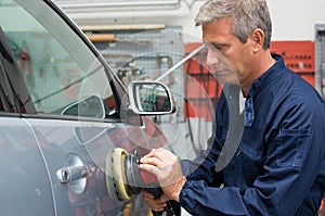 Auto Mechanic Polishing Car