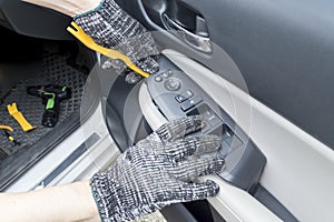 Auto mechanic remove car window controls panel, Car maintenance service