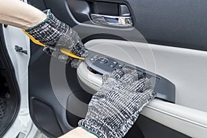 Auto mechanic remove car window controls panel, Car maintenance service