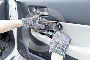 Auto mechanic remove car window controls panel, Car maintenance service