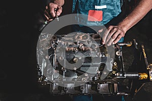 Auto mechanic repairing a car engine. Car maintenance concept