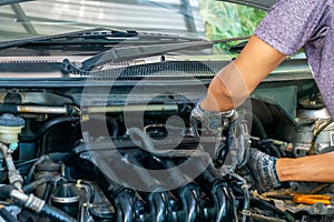 Auto mechanic repairing car. Selective focus in Thailand