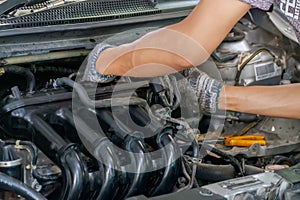 Auto mechanic repairing car. Selective focus in Thailand