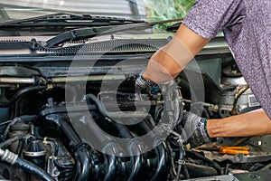 Auto mechanic repairing car. Selective focus in Thailand