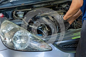 Auto mechanic repairing car. Selective focus in Thailand