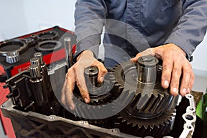 An auto mechanic repairs a truck engine. Service of trucks in the garage. Close-up
