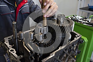 An auto mechanic repairs a truck engine. Service of trucks in the garage. Repair and diagnostics, Close-up.