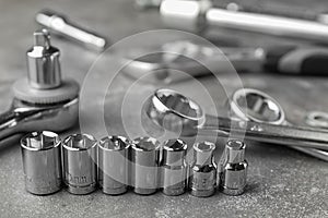 Auto mechanic`s tools on grey stone table