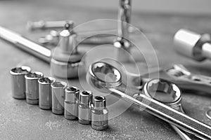 Auto mechanic`s tools on grey table