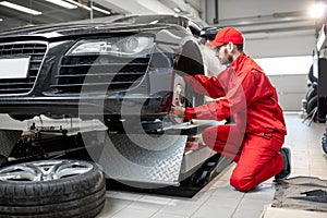 Auto mechanic servicing sports car