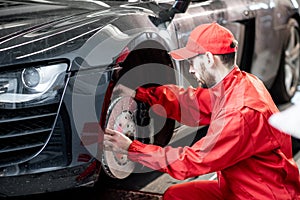 Auto mechanic servicing sports car
