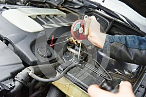 Auto mechanic tests car antifreeze liquid photo