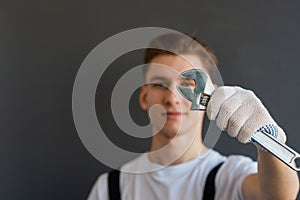 Auto mechanic with tool on blurred background