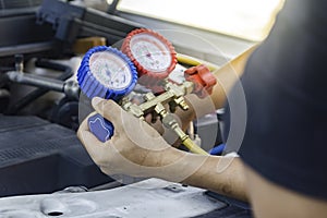 Auto mechanic uses a pressure gauge on the air compressor,liquid air pressure,compressor,manometer in a car.