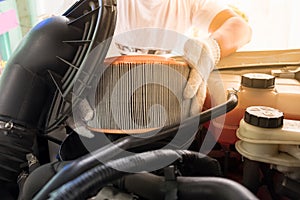 auto mechanic wearing protective work gloves holding a dirty