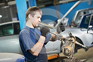 Auto mechanic at work with wrench spanner