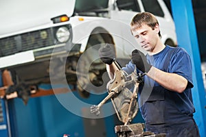 Auto mechanic at work with wrench spanner