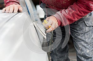 Auto mechanic worker polishing the basic layer