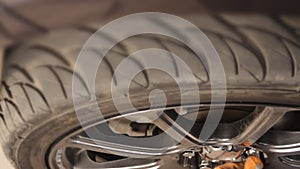 Auto mechanic working on brakes in a car repair shop domestic garage.