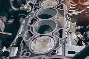 Auto mechanic working on car engine in mechanics garage. the cylinder block