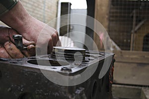 An auto mechanic is working on a car engine in a mechanics garage. Repair service. authentic close-up shot. VAZ 2106