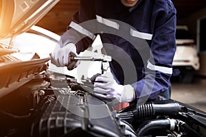 Auto mechanic working on car engine in mechanics garage.Repair service,car service, repair, maintenance concept