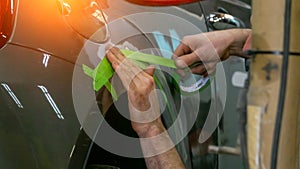 Auto mechanic working on car paint sanding in mechanics garage. workshop repair service. authentic close-up shot