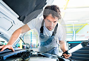Auto mechanic working in car service